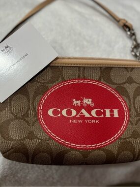 Coach Brown Signature Canvas Wristlet with Red Logo Patch